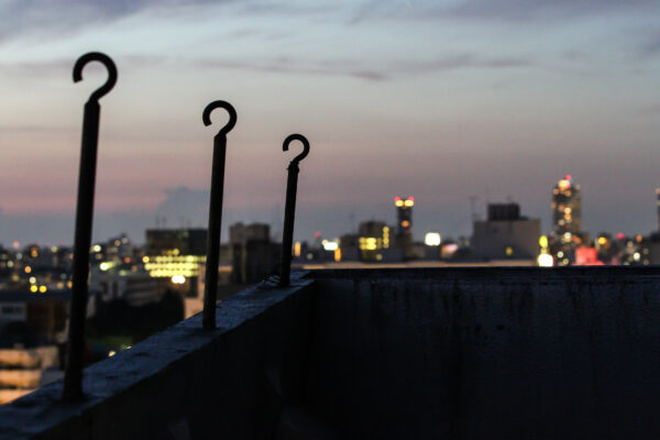 Modern marvel: Shinjuku Metabolism building shines in city lights with sleek design.