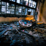 Decaying hospital room on Gunkanjima, Nagasaki: abandoned medical equipment and haunting atmosphere.