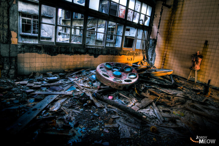 Decaying hospital room on Gunkanjima, Nagasaki: abandoned medical equipment and haunting atmosphere.