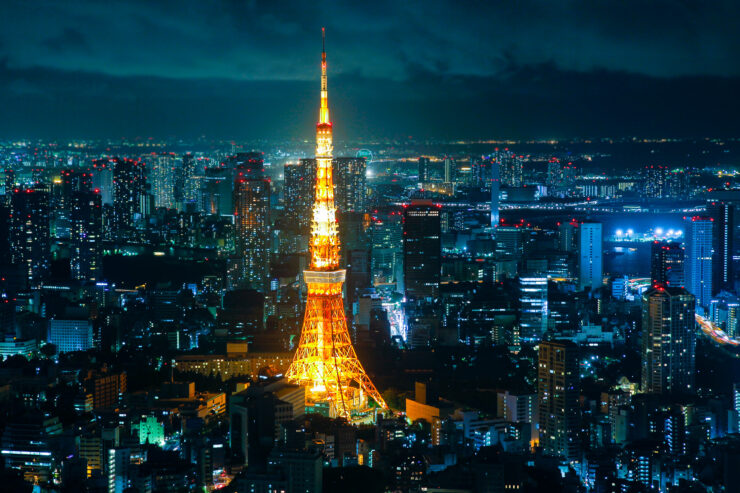 Tokyo Tower at night: iconic landmark in Japans capital, illuminated in golden light.