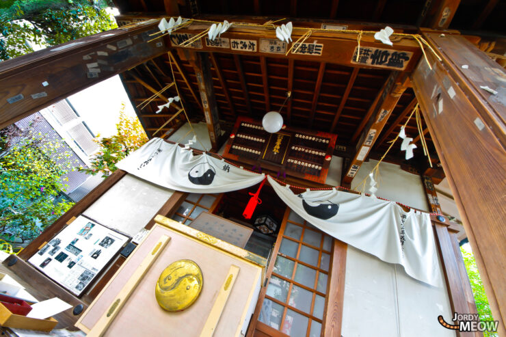 Traditional Japanese shrine interior with wooden beams, lanterns, and serene atmosphere in Tokyo.