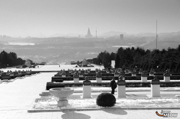 North Korea fountain garden with grand water feature, formal landscaping, and Pyongyang skyline backdrop.