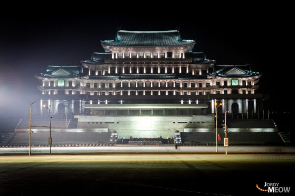 Night view of majestic government building in Pyongyang, showcasing unique architectural style and cultural heritage.