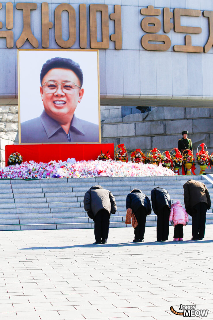 Workers Party Monument Ceremony in North Korea, honoring Kim Jong-Il with traditional and modern architecture.