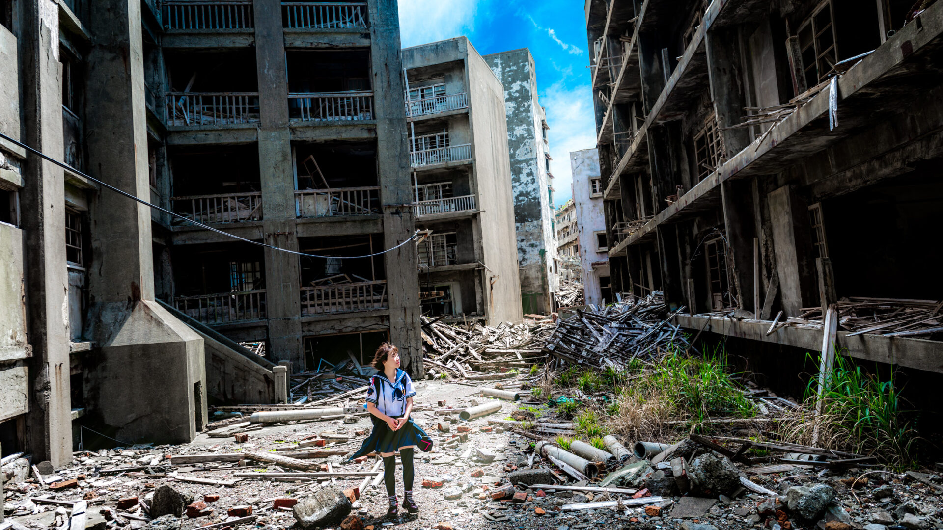 Exploring Gunkanjima: A lone explorer amidst haunting urban decay in Nagasaki, Japan.