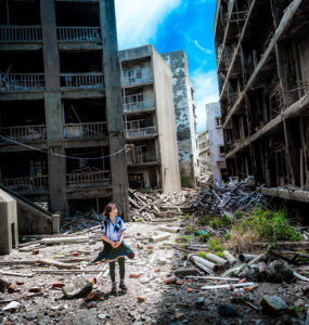 Exploring Gunkanjima: A lone explorer amidst haunting urban decay in Nagasaki, Japan.