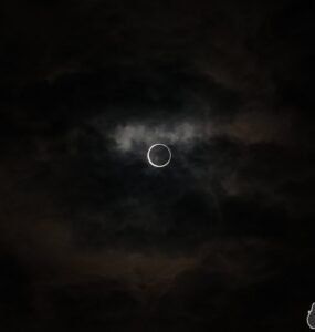 Solar eclipse with suns corona against dark, cloudy sky in Japan 2012.