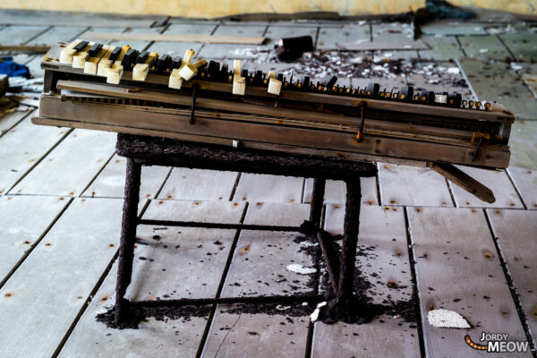 Desolate piano in abandoned Gunkanjima, Japan, evokes haunting sense of lost melodies.