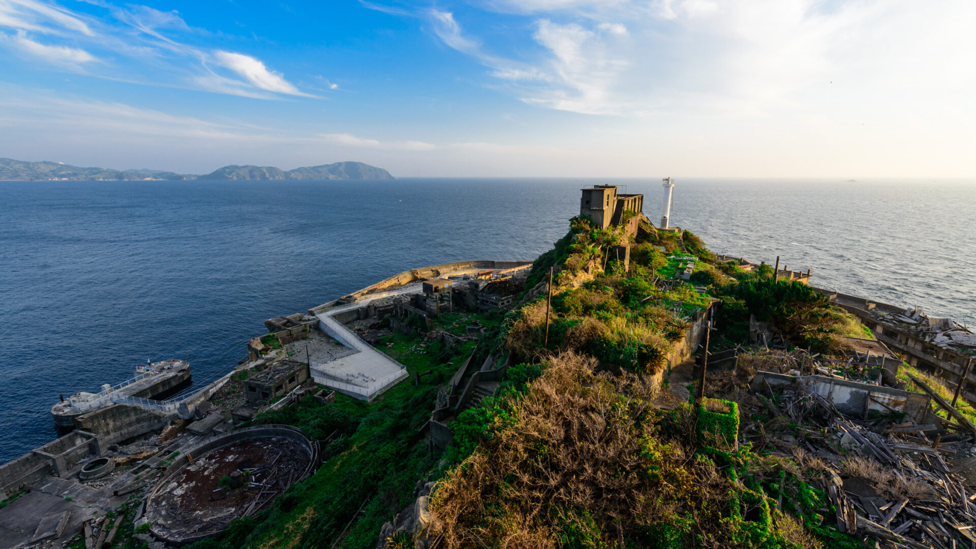 Sunset Over Abandoned Gunkanjima - Eerie landscape of Gunkanjima at sunset, with crumbling buildings.