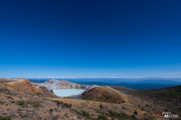 Majestic Mount Shirane: Volcanic beauty with emerald crater lake in Japan.