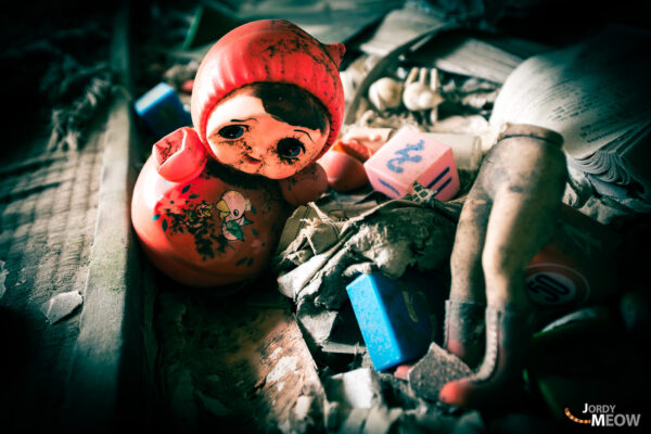 Resilient Matryoshka amidst Gunkanjimas Decaying Ruins: Urban Exploration in Japan.