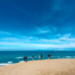 Sands of Serenity: Golden dunes against blue skies and turquoise waters in Tottori, Japan.