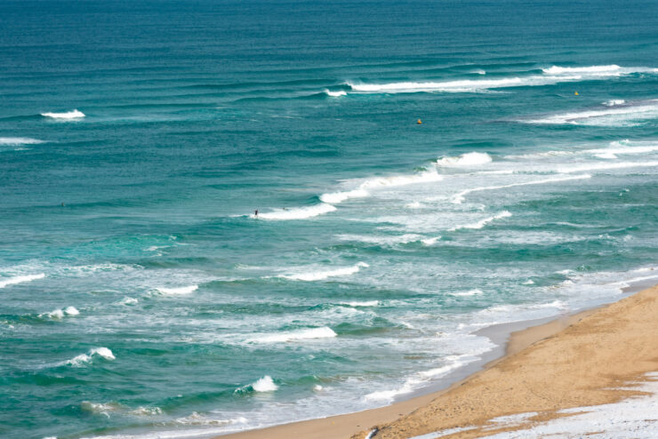 Breathtaking Tottori Sand Dunes in Japan: golden sands, turquoise waters, and serene beauty.