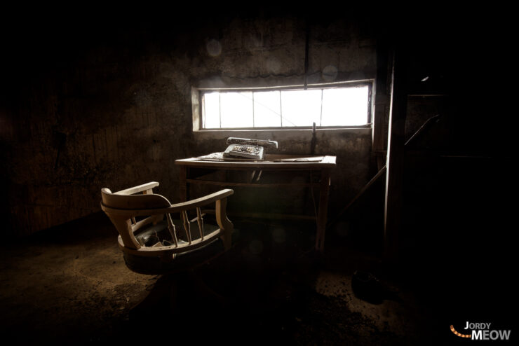 Abandoned accountants office on Gunkanjima, showcasing isolation and decay of Nagasakis ghost island.