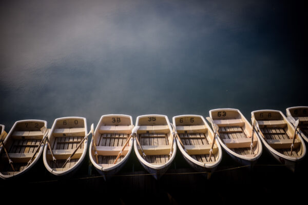 Mount Bandai Volcanic Lakes with row boats on serene waters under a dramatic sky.