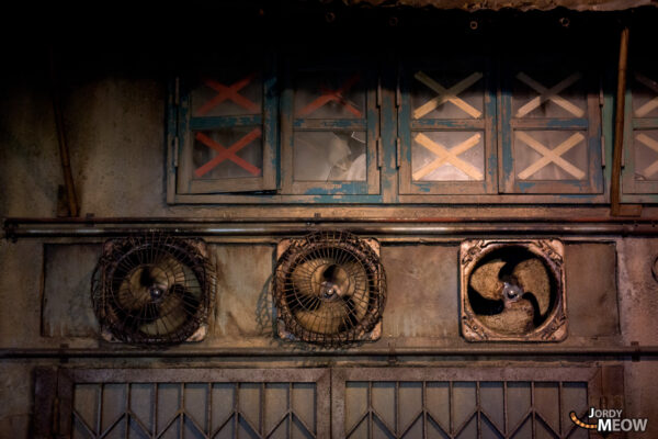 Decaying Japanese gaming center with weathered fans evokes haunting urban exploration atmosphere.