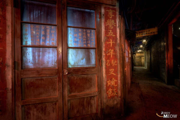 Exploring Kowloon Walled City gaming center with dimly lit, mysterious atmosphere.