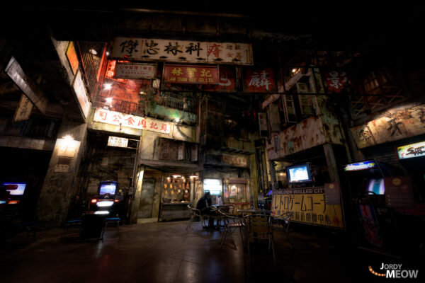 Immersive gaming center in abandoned warehouse with Kowloon Walled City theme.