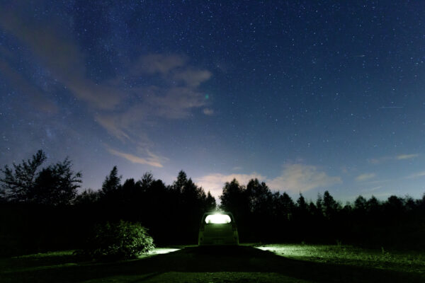 Enchanting Blue Pond night scene with vibrant blue waters reflecting starry sky.