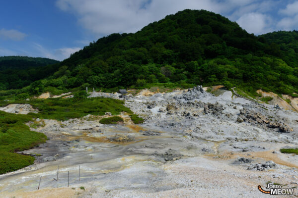 Sacred Volcano: Mount Osore in Aomori, Japan - serene, spiritual landscape amidst lush greenery.