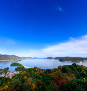 Awe-inspiring Amanohashidate sandbar with lush surroundings and majestic mountains in Japan.