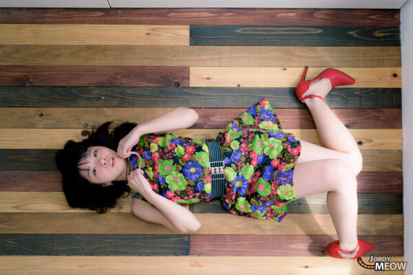 Playful retro vibes: Miki in Tokyos Nakagin Capsule Tower with vibrant 70s dress.