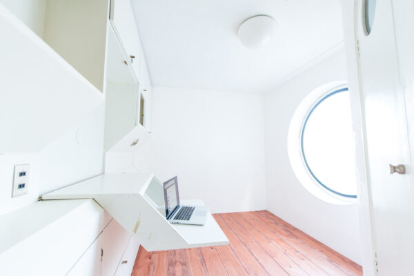 Innovative living space inside Nakagin Capsule Tower, Tokyo: compact design with circular window.