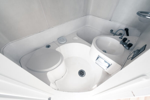 Minimalist bathroom in Nakagin Tower, Tokyo, showcasing efficient design in compact living space.