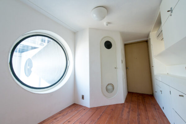 Innovative living space in Nakagin Capsule Tower, showcasing minimalist design and cityscape views.