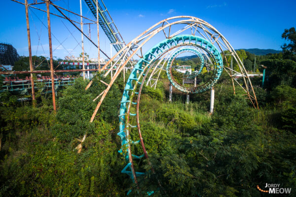 Decaying roller coaster reclaimed by nature at abandoned Nara Dreamland theme park in Japan.