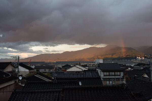 Enchanting Shiroyone Senmaida: Stunning terraced rice fields with vibrant rainbow in Japan.