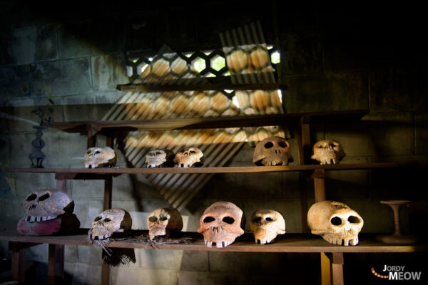 Mysterious shrine with handmade skulls in abandoned tower invites intrigue and unease.