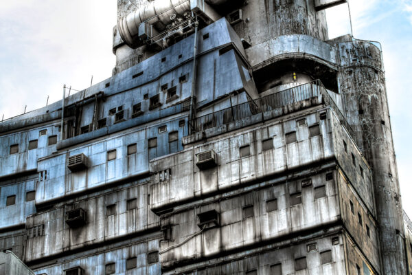 Abandoned industrial icon: The New Sky Building, showcasing brutalist architecture and decay.