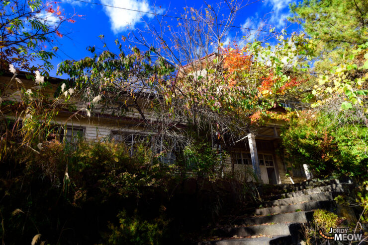 Exploring abandoned Nichitsu Mine in autumn, showcasing industrial history and nature reclaiming space.