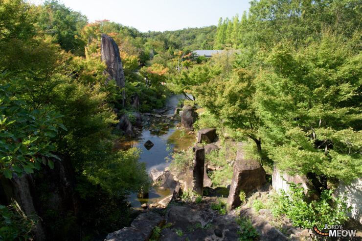 Magical Totoro House nestled in lush Aichi forest, inspired by iconic anime film.