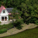 Charming Totoro House replica in Nagoya, Japan - whimsical design nestled in lush greenery.