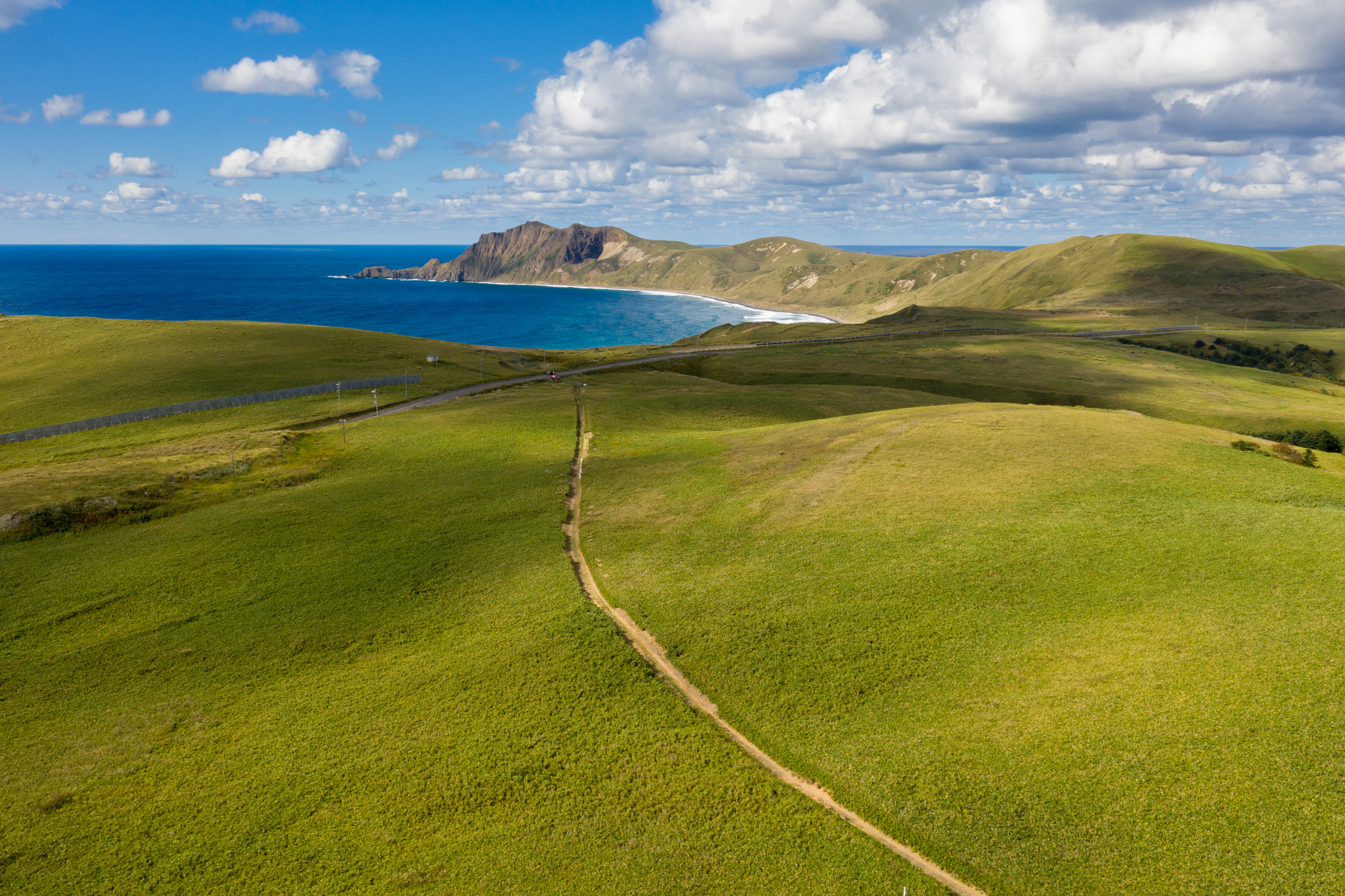 Lush Rebun Island, Hokkaidos serene meadows, azure sea.