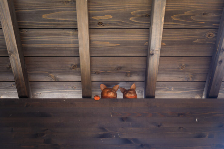 Traditional Japanese Street with Whimsical Cat Carvings