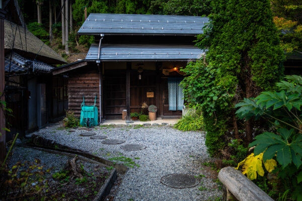 Traditional Japanese wooden architecture, natural surroundings.