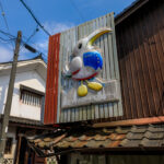 Vibrant sculpture adorns traditional Japanese building.
