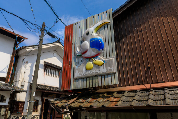 Vibrant sculpture adorns traditional Japanese building.