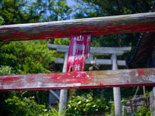 Striking Japanese torii gate in lush greenery.