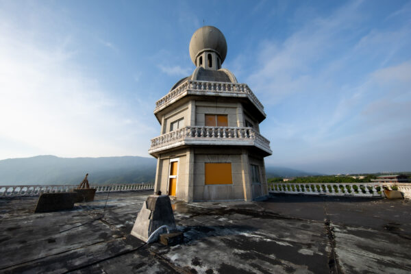 Abandoned ornate Japanese royal hotel in nature