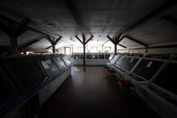 Dimly lit abandoned arcade remnant