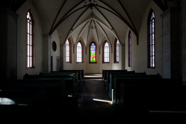 Haunting abandoned Gothic church interior architecture.