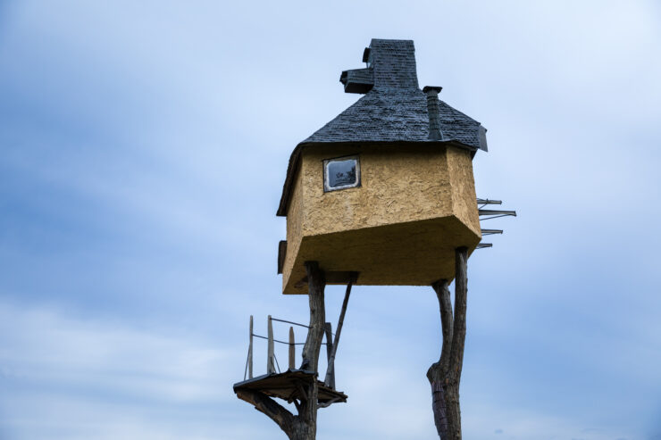 Elevated rustic Japanese teahouse pavilion with thatched roof