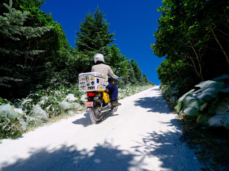 Scenic motorcycle ride through verdant Soya Hills.