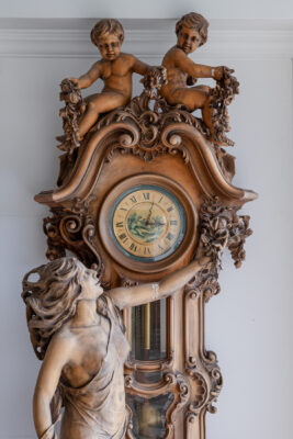 Ornate antique wooden mansion clock, intricate carvings