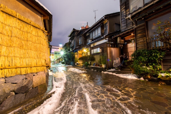 Enchanting snowy Kanazawa street with traditional architecture.