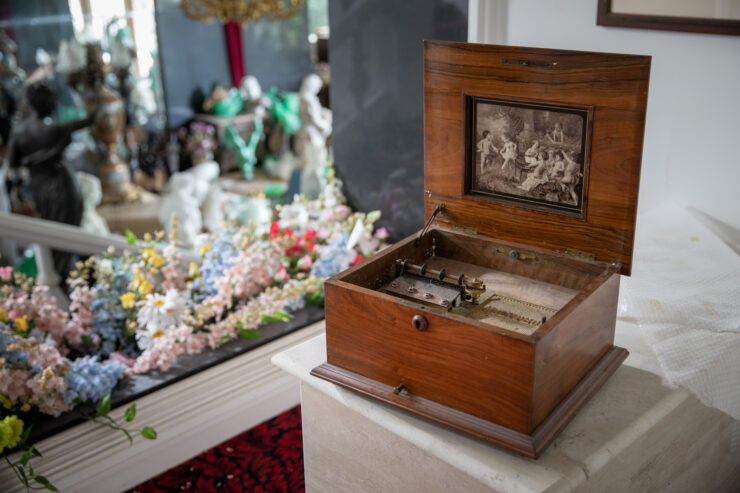 Antique carved wooden jewelry box, floral backdrop